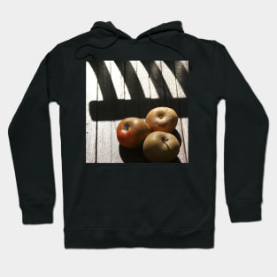 Three apples on a chair Hoodie